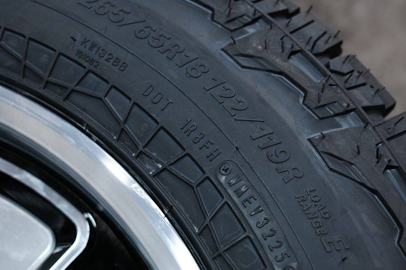 A tyre sidewall showing the size marking LT265/65R18.