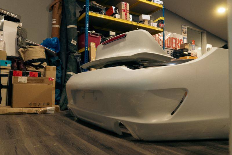 A white composite rear bumper with a raised ducktail, from Project Singa.