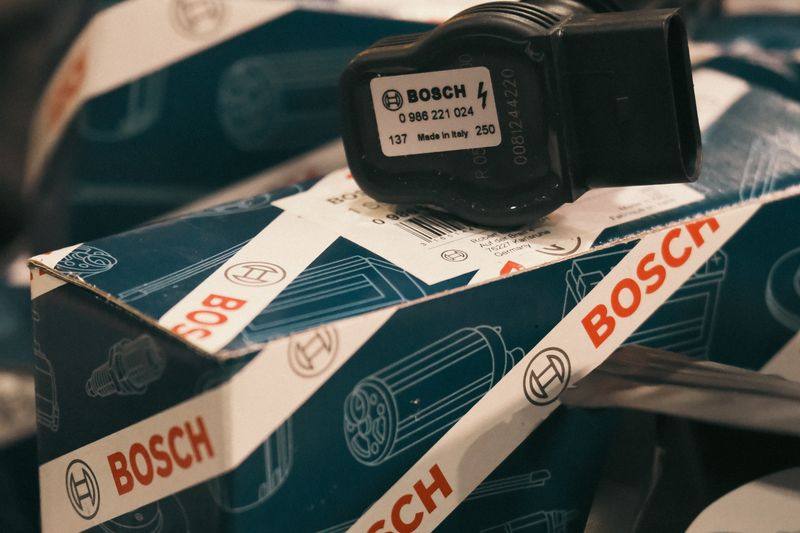 A Bosch sensor sitting on its box among other boxed components.
