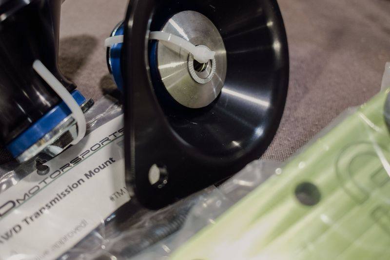 A black engine mount and a bagged transmission mount marked AWD Transmission Mount.